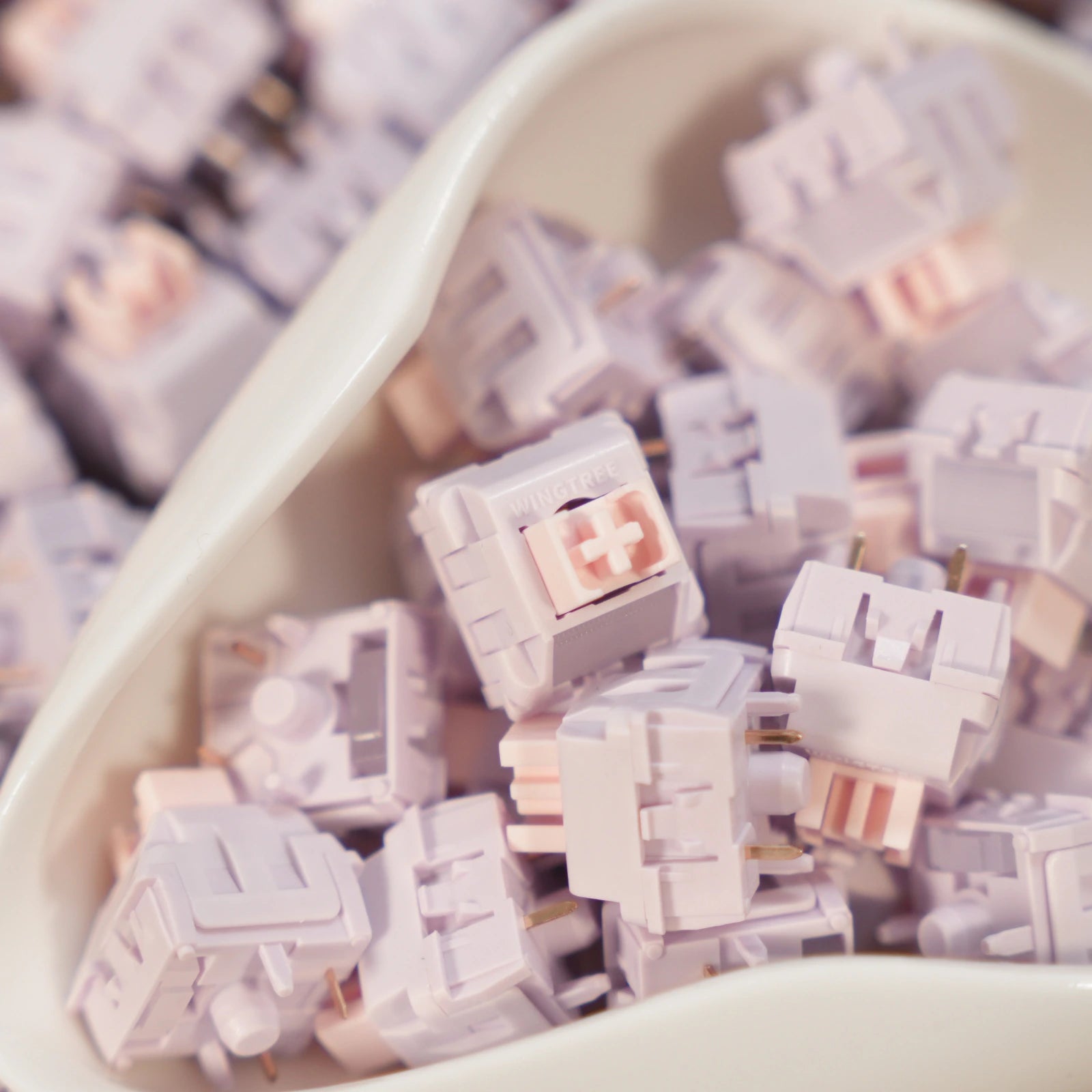 Light purple keyboard switches in a white container