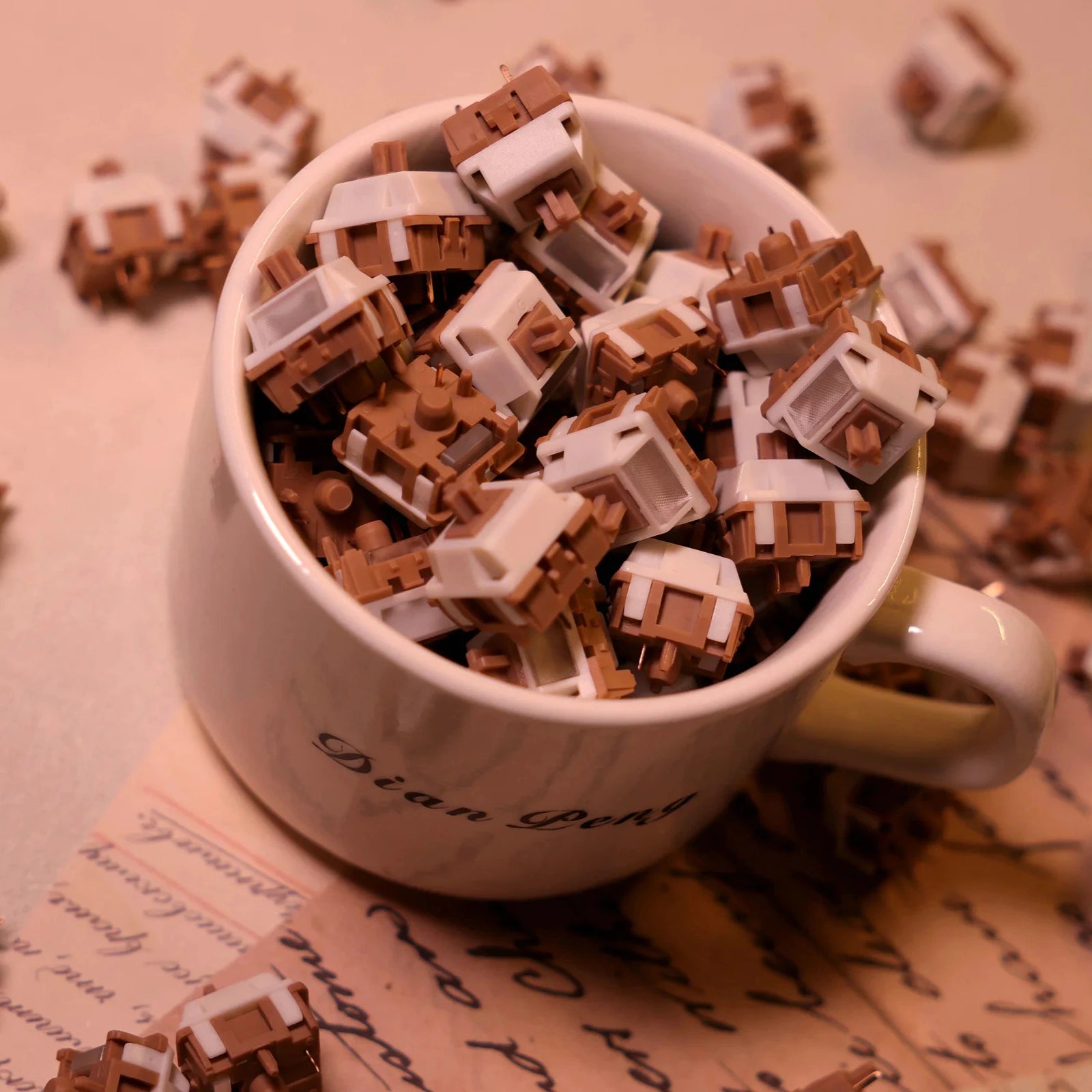 White mug filled with brown and beige keyboard switches