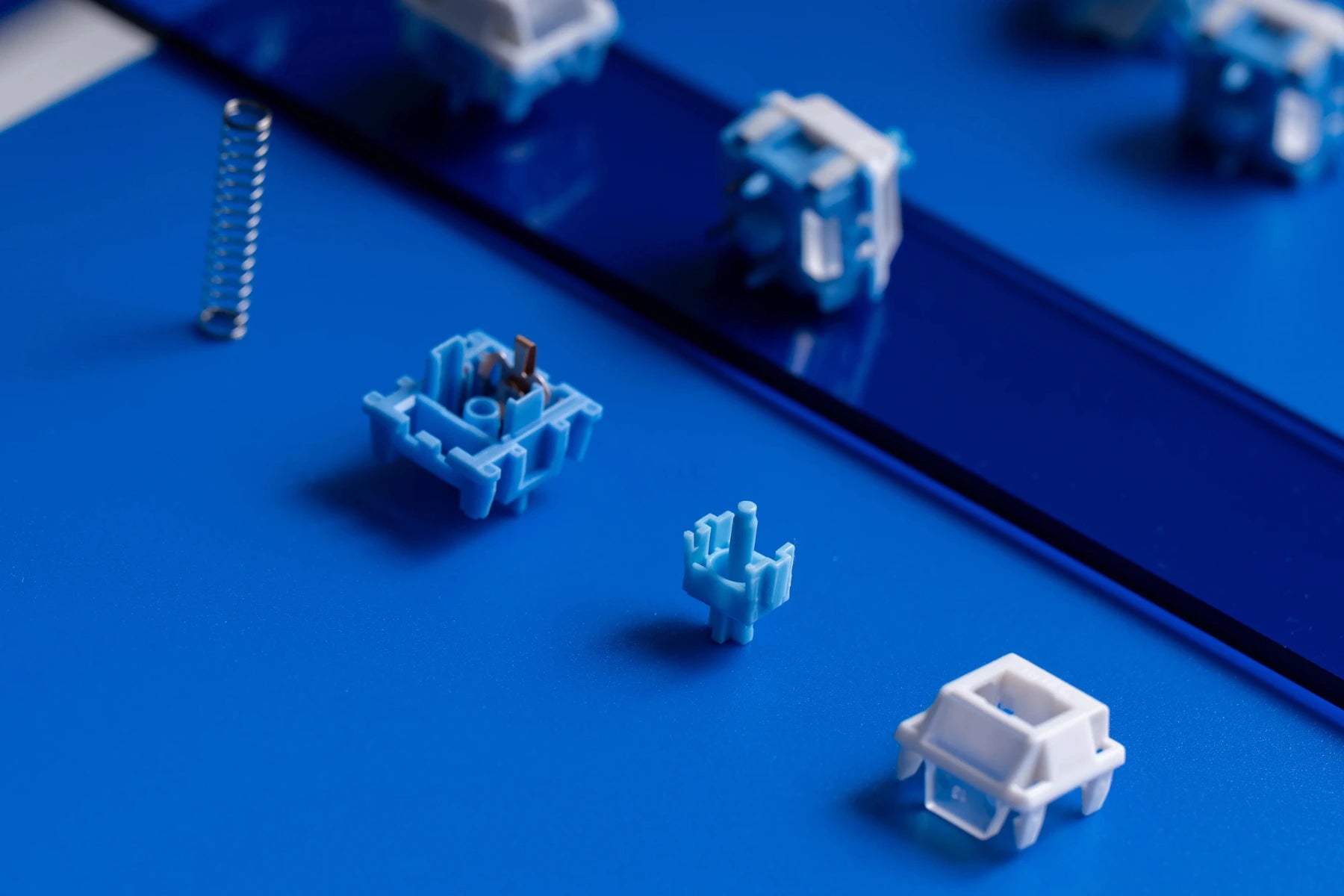 Blue and white mechanical keyboard switch on a blue background